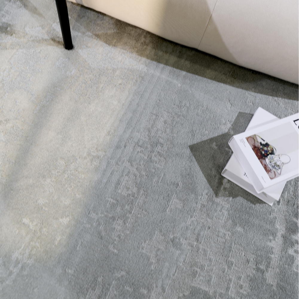 Chic gray woven rug under modern sofa, perfect for contemporary home decor.