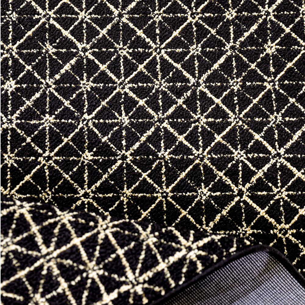 Black and gold geometric woven rug with intricate diamond pattern