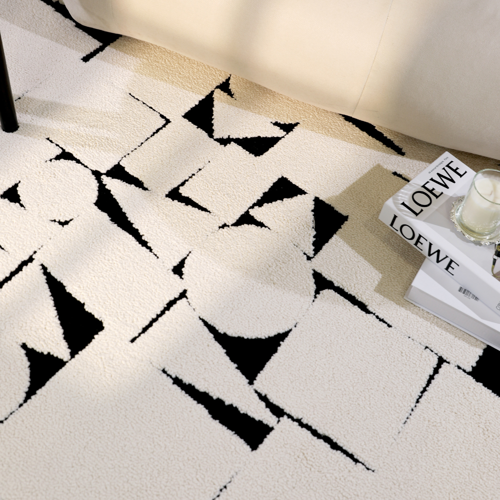 Abstract geometric rug with black shapes on cream background in modern living room.