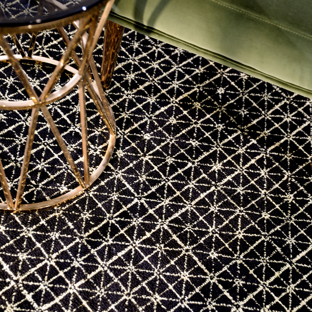 Geometric black and cream woven rug in a contemporary living room setting