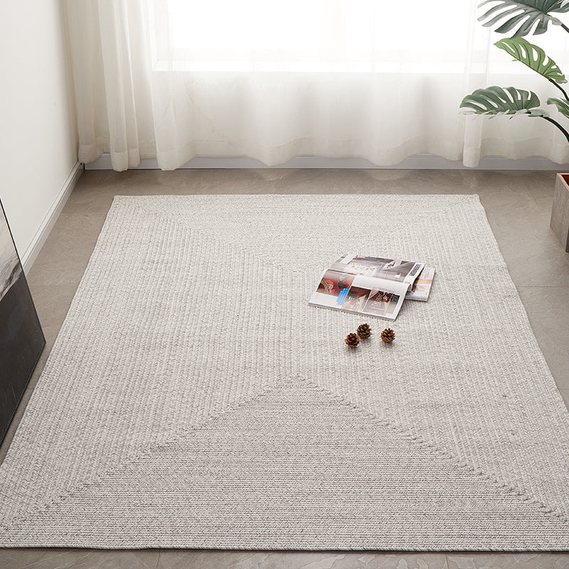 Grey hand-woven outdoor rug, customizable size, elegant design for any space.