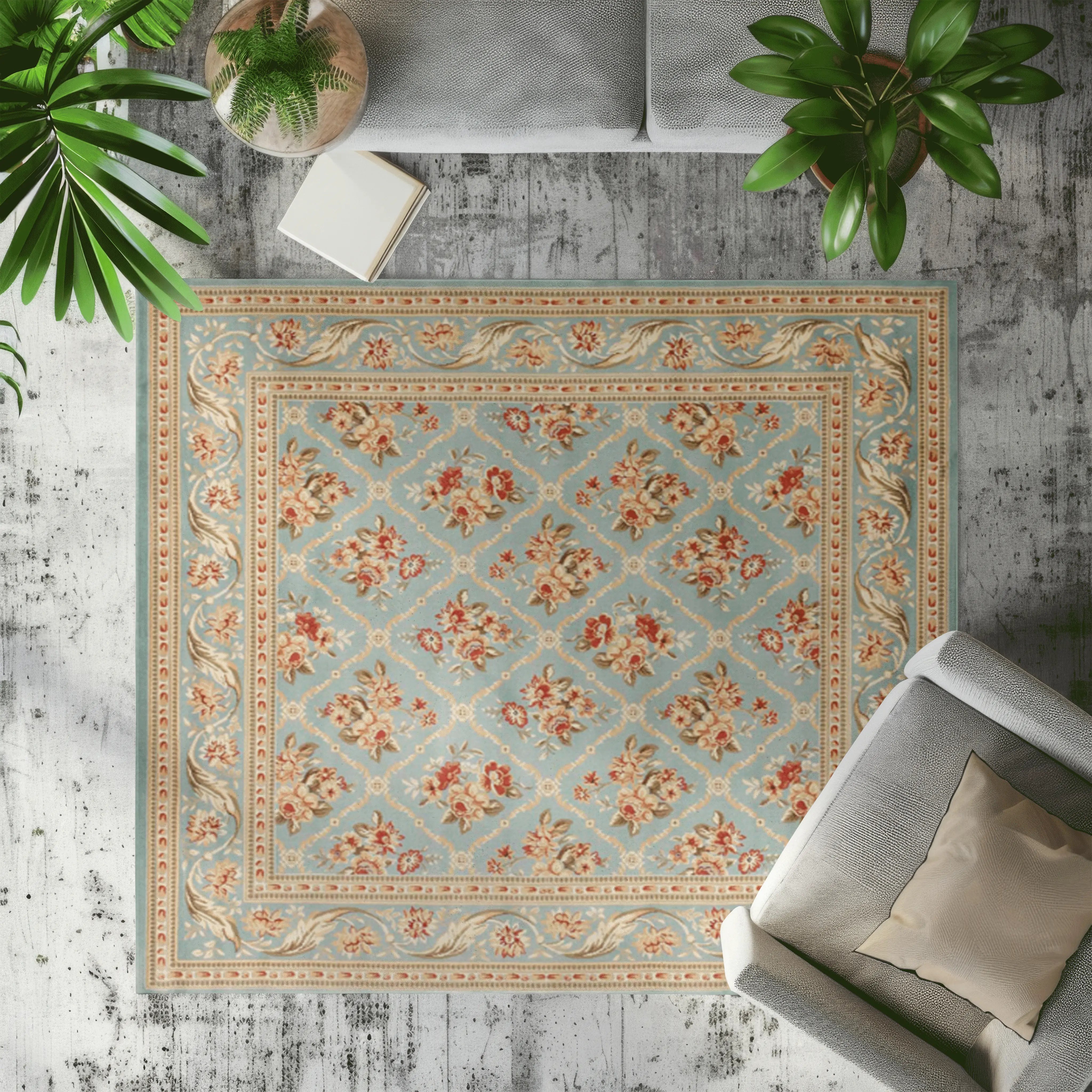 Vintage floral area rug in soft blue, red, and gold, enhancing bright living room decor.