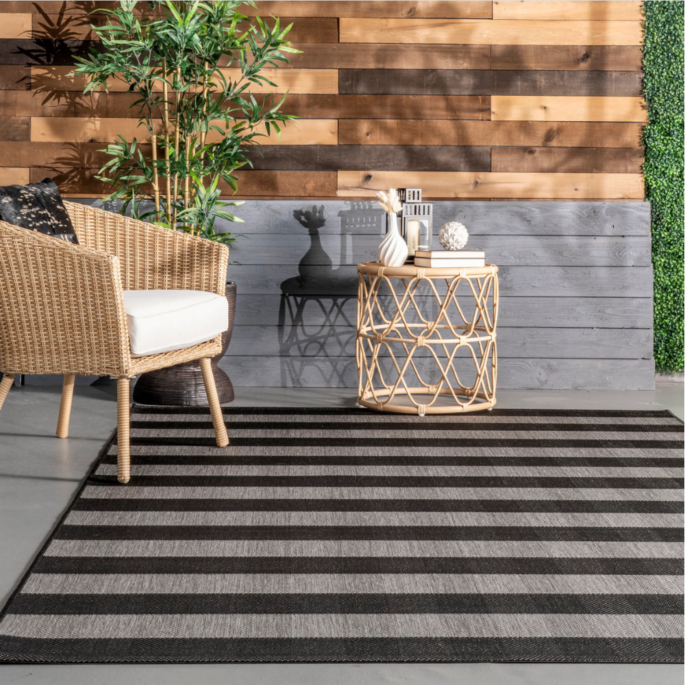Black and cream striped washable rug enhancing modern living space decor.