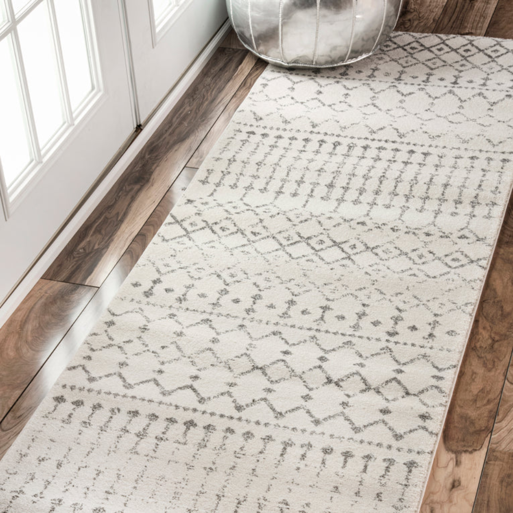 Fiona Moroccan washable rug with gray and cream geometric design on wooden floor.