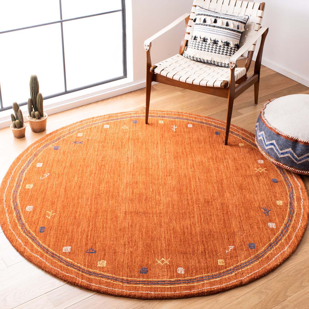 Round orange geometric rug with blue and cream accents in modern living room