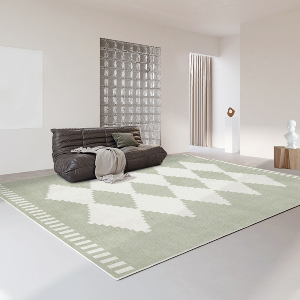 Geometric diamond-patterned green vintage rug in a modern living room setting.