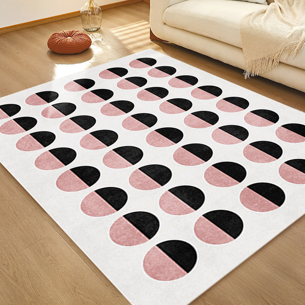 Geometric rug with pink and black half-circle pattern in a contemporary living room