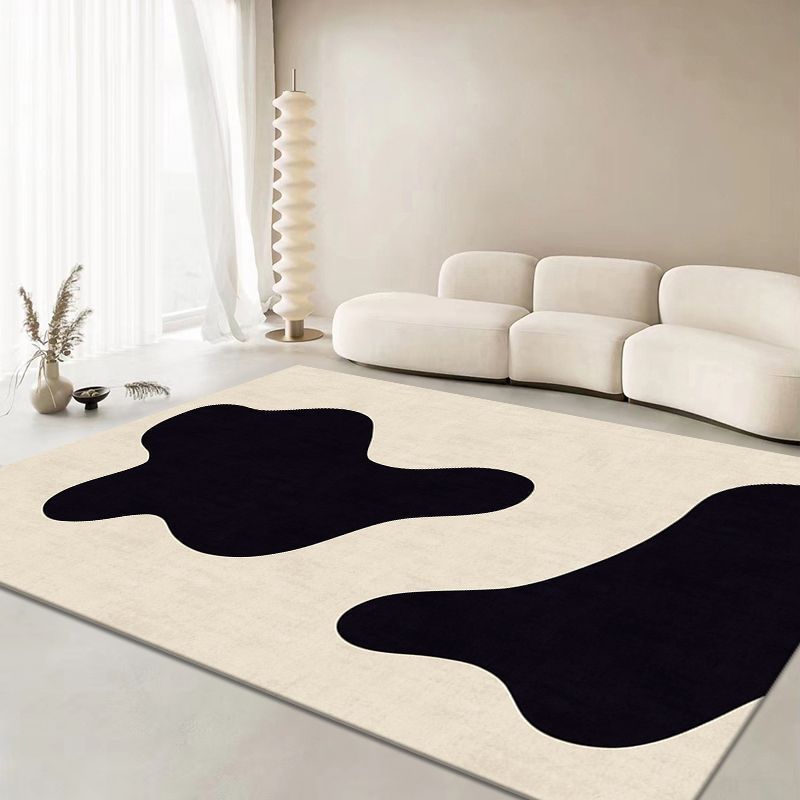 Contemporary beige rug with black shapes, ideal for modern home decor