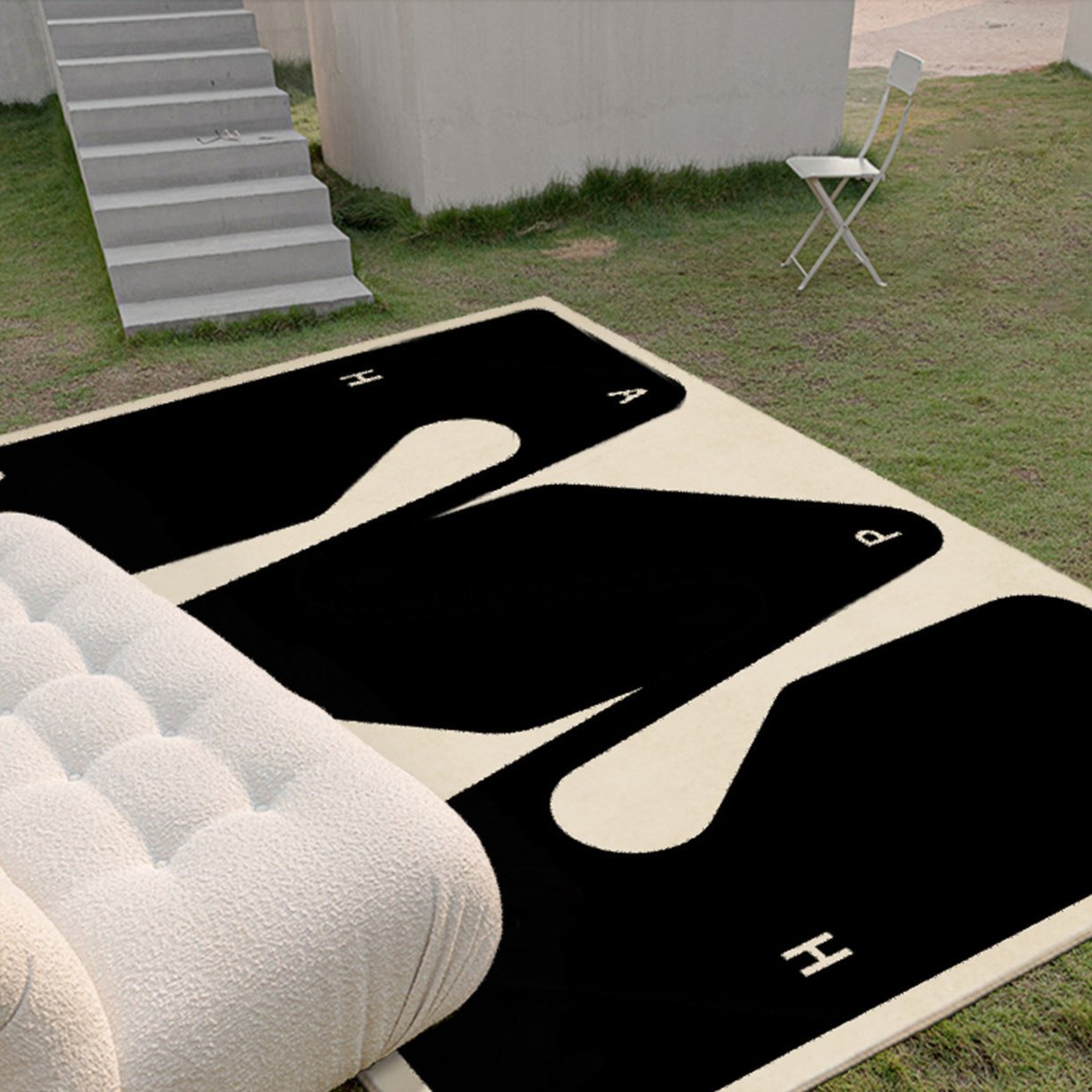 Abstract black and beige Morpho washable rug in outdoor setting