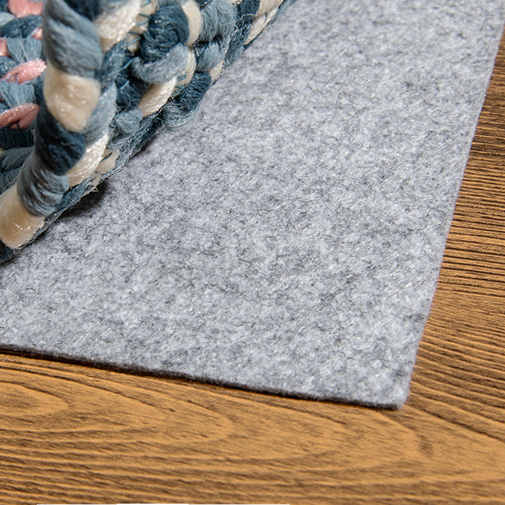 Detail of Starlit Horizon Stria outdoor rug with braided edge and soft felt backing.
