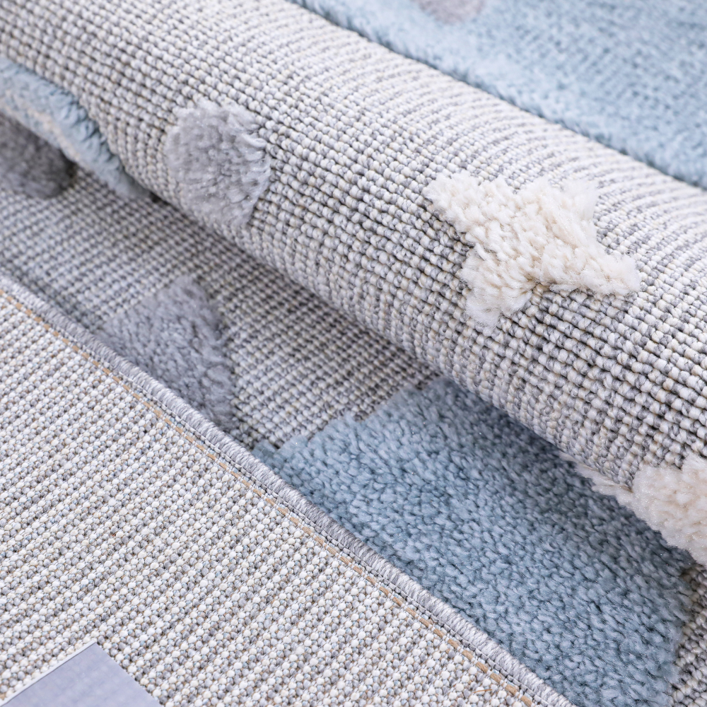 Gentle Tides Whale Woven Rug close-up featuring soft textures and playful star motifs.