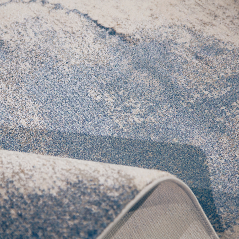 Mira Abstract Textured Rug in blue hues, soft texture, and machine-washable design.