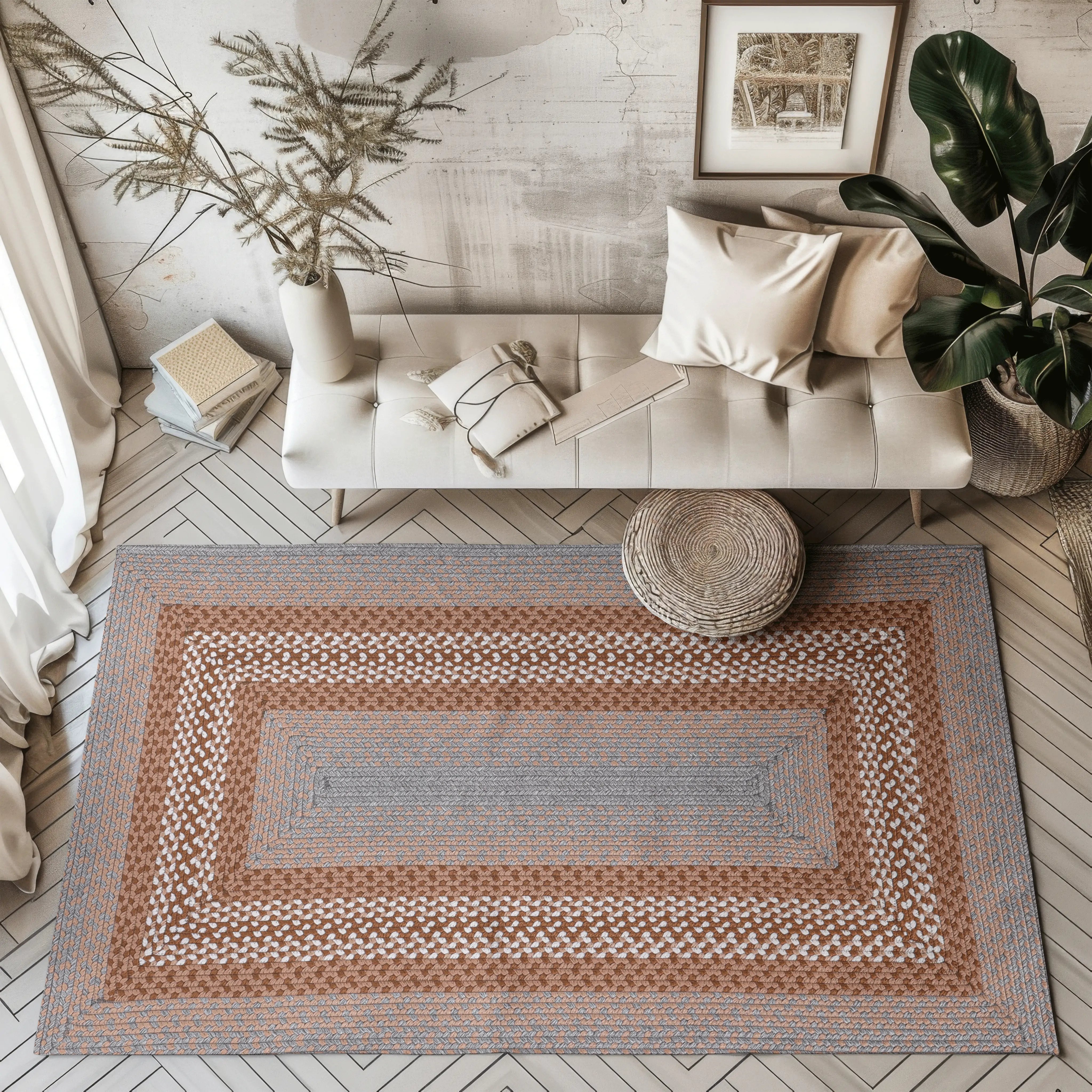 Hand-woven outdoor rug with gray and brown geometric pattern in a contemporary living room.