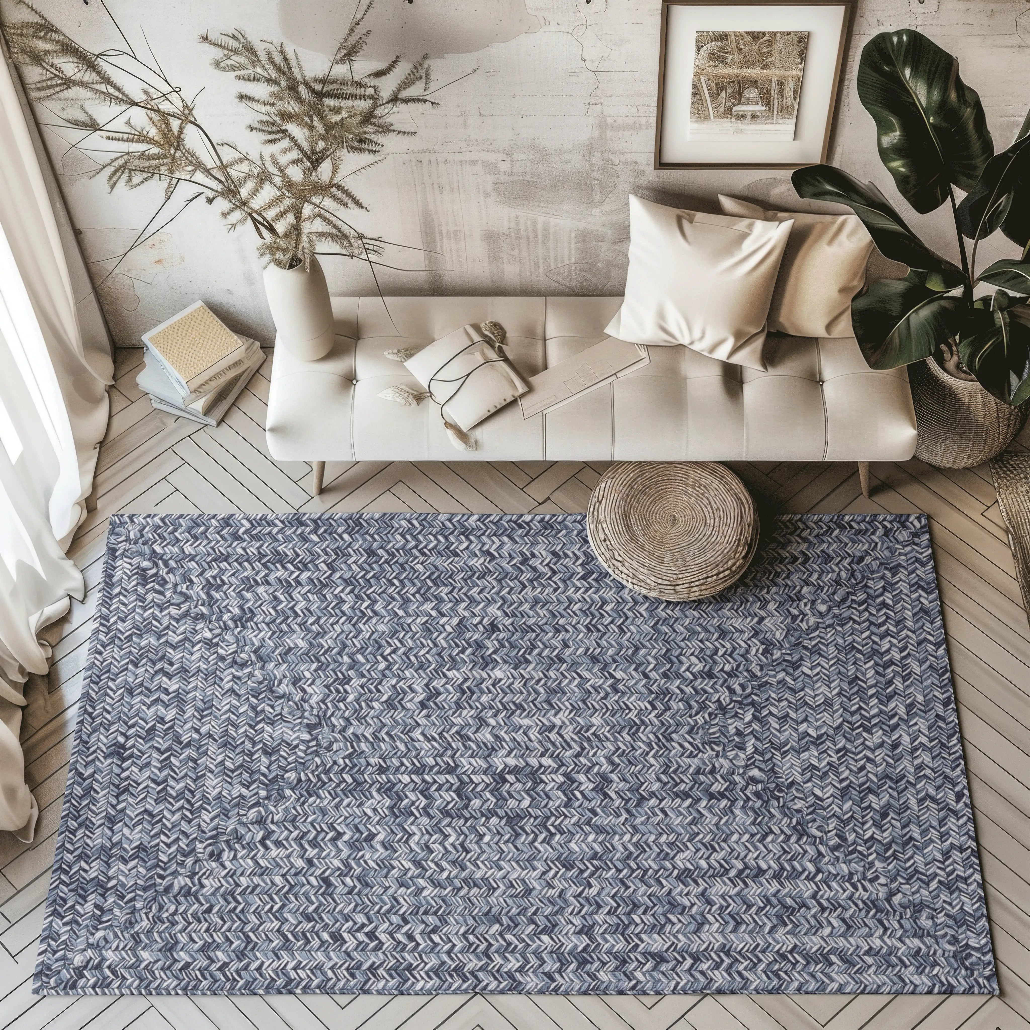 Hand-braided outdoor rug in blue and white chevron design on modern living room floor