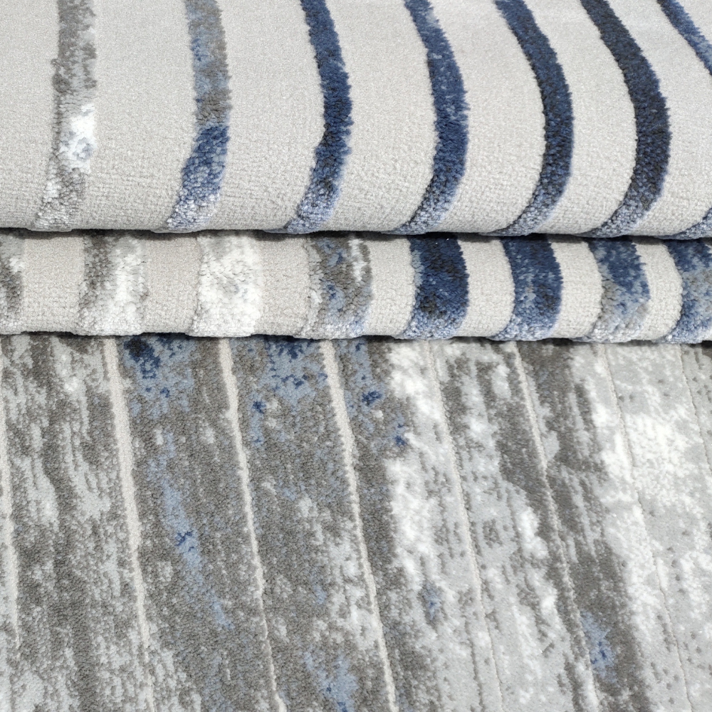 Silas Abstract Textured Rug with layered blue and gray stripes