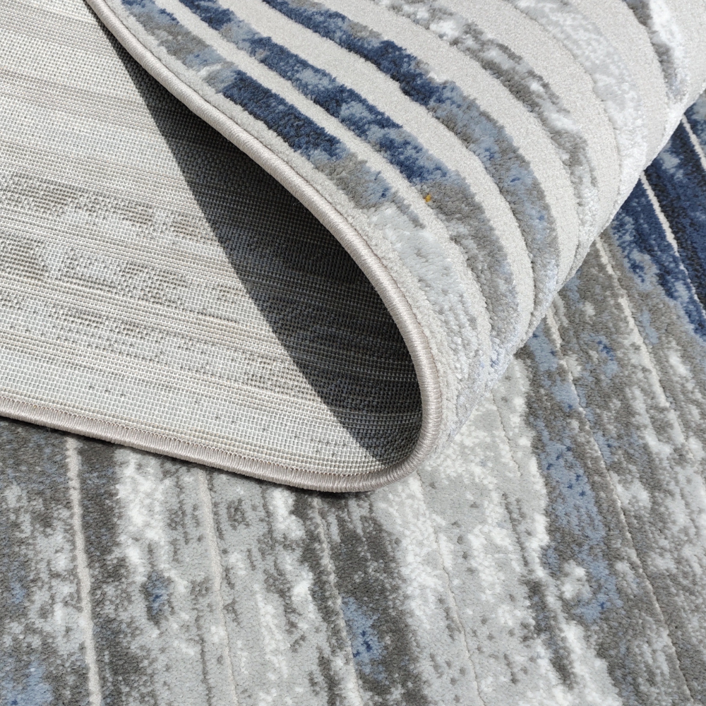 Silas Abstract Textured Rug featuring blue, gray, and gold striped design