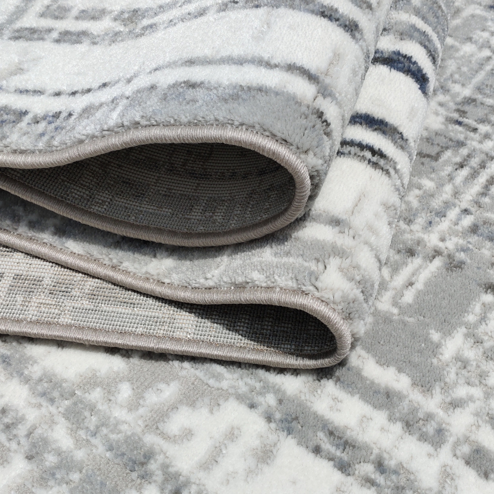 Flora Abstract Textured Rug showcasing gray and navy geometric patterns.