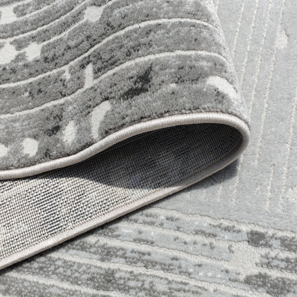 Freya Abstract Textured Rug showcasing gray and silver tones, machine washable design.