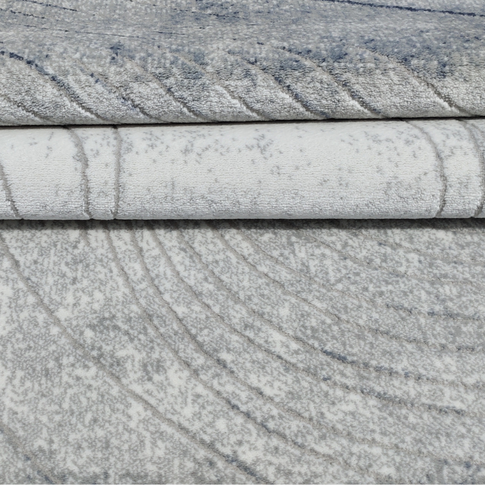 Mia Abstract Textured Rug showcasing wave patterns in blue and grey tones.