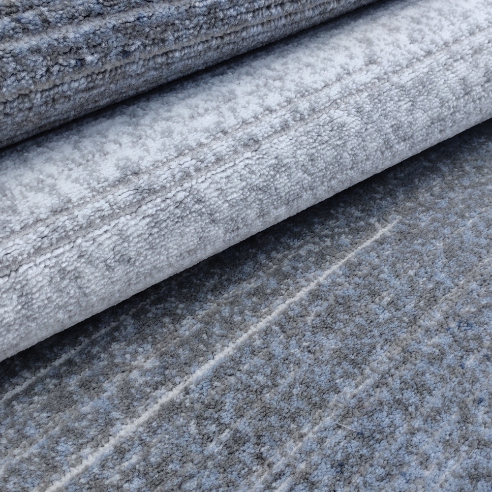 Abstract blue and gray textured rug, ideal for stylish and modern interiors.