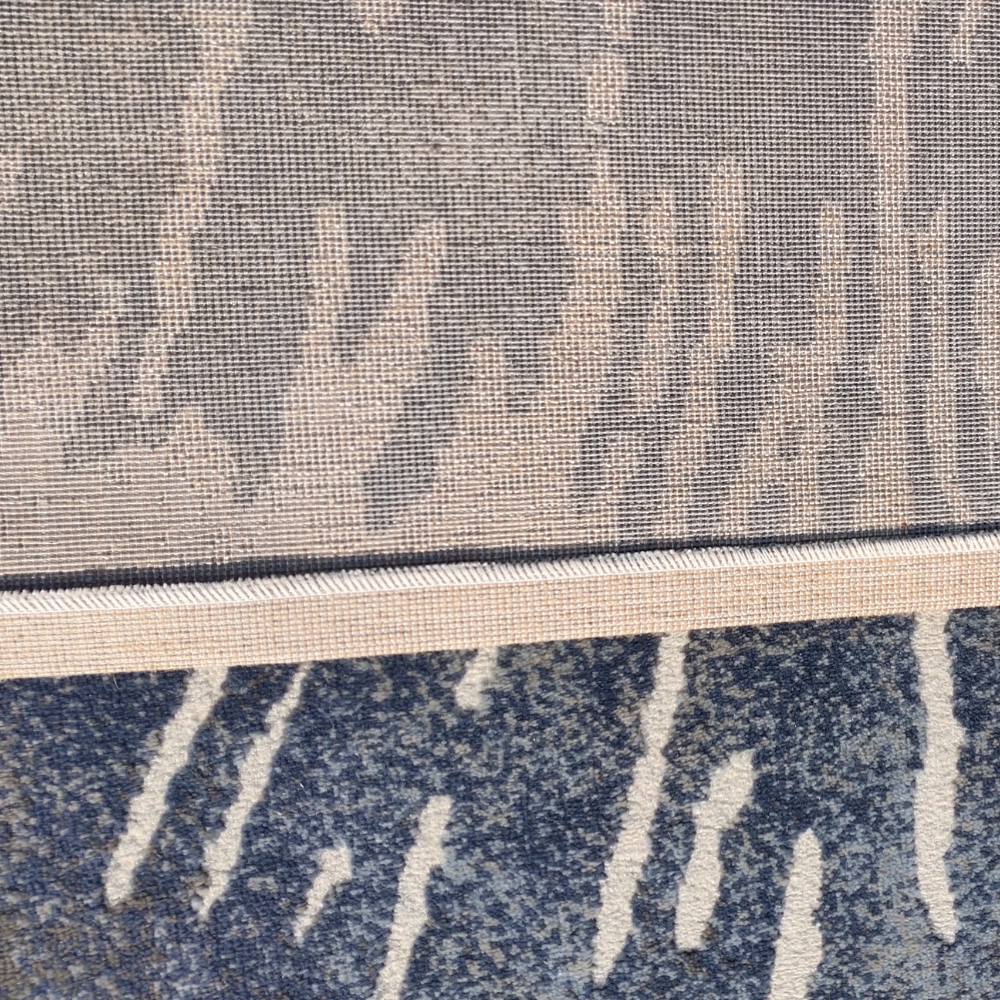 Poppy Abstract Textured Rug Arith detail in blue and cream, featuring a modern design.