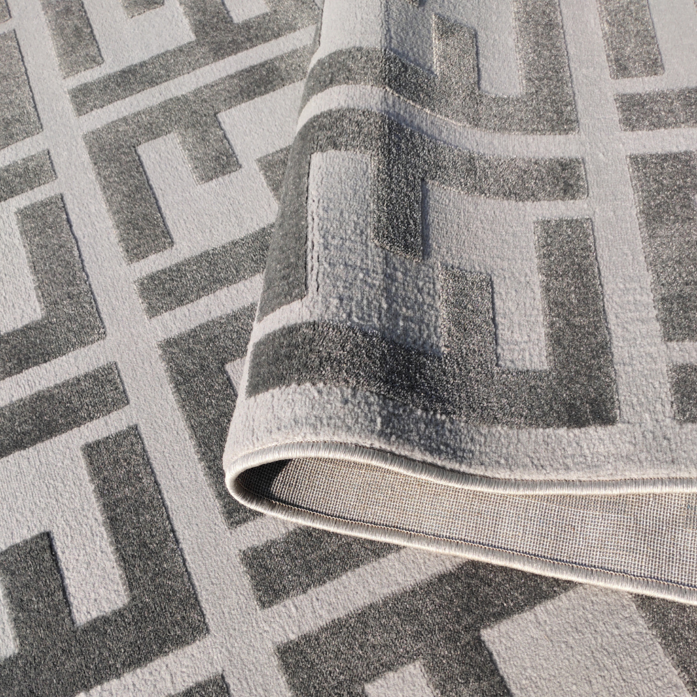 Contemporary gray rug featuring interlocking geometric patterns.