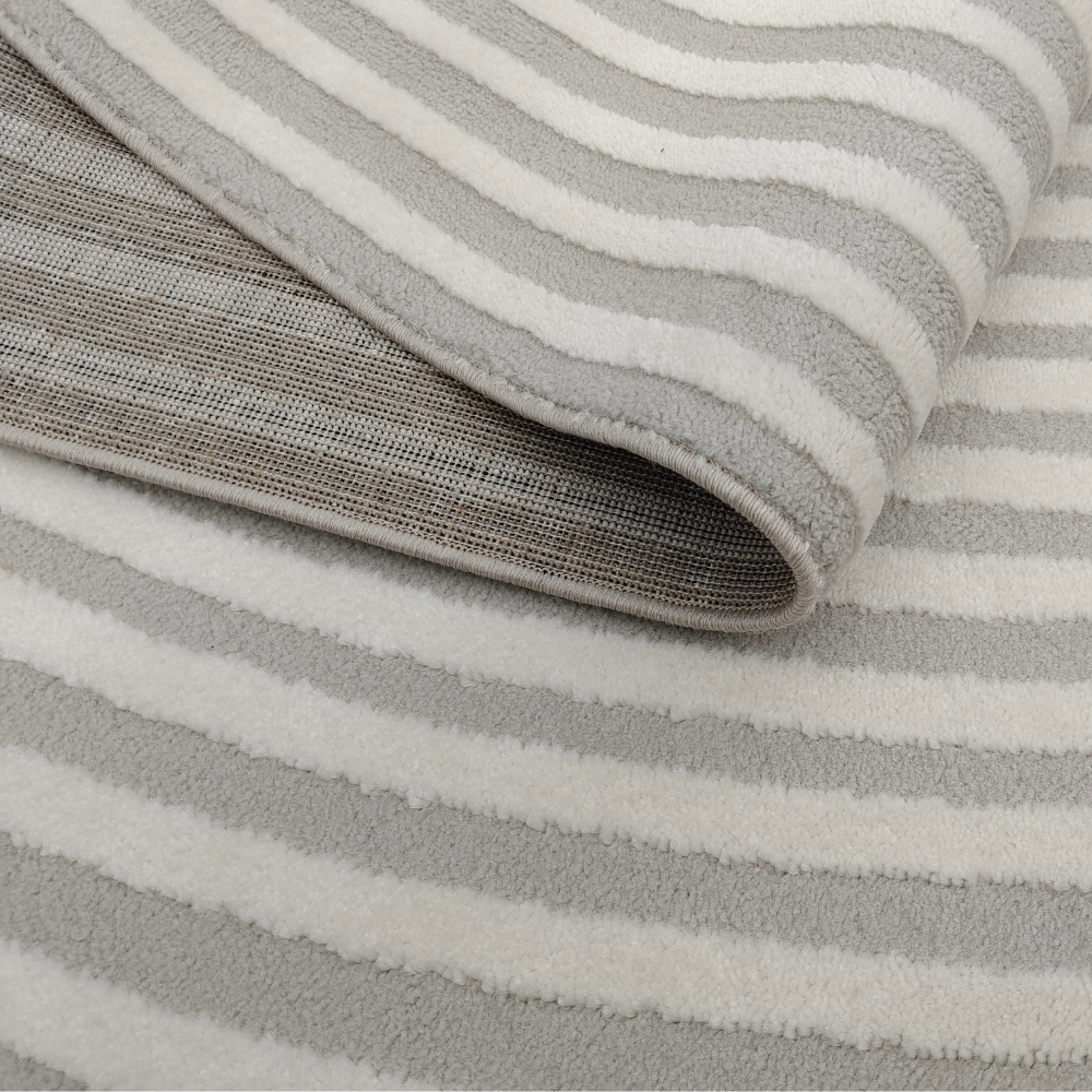 Vero textured rug with soft grey and cream stripes, ideal for home decor.
