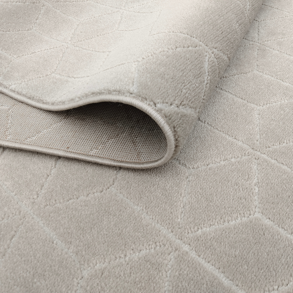 Neutral Peregrine geometric rug showcasing textured surface and folded edge