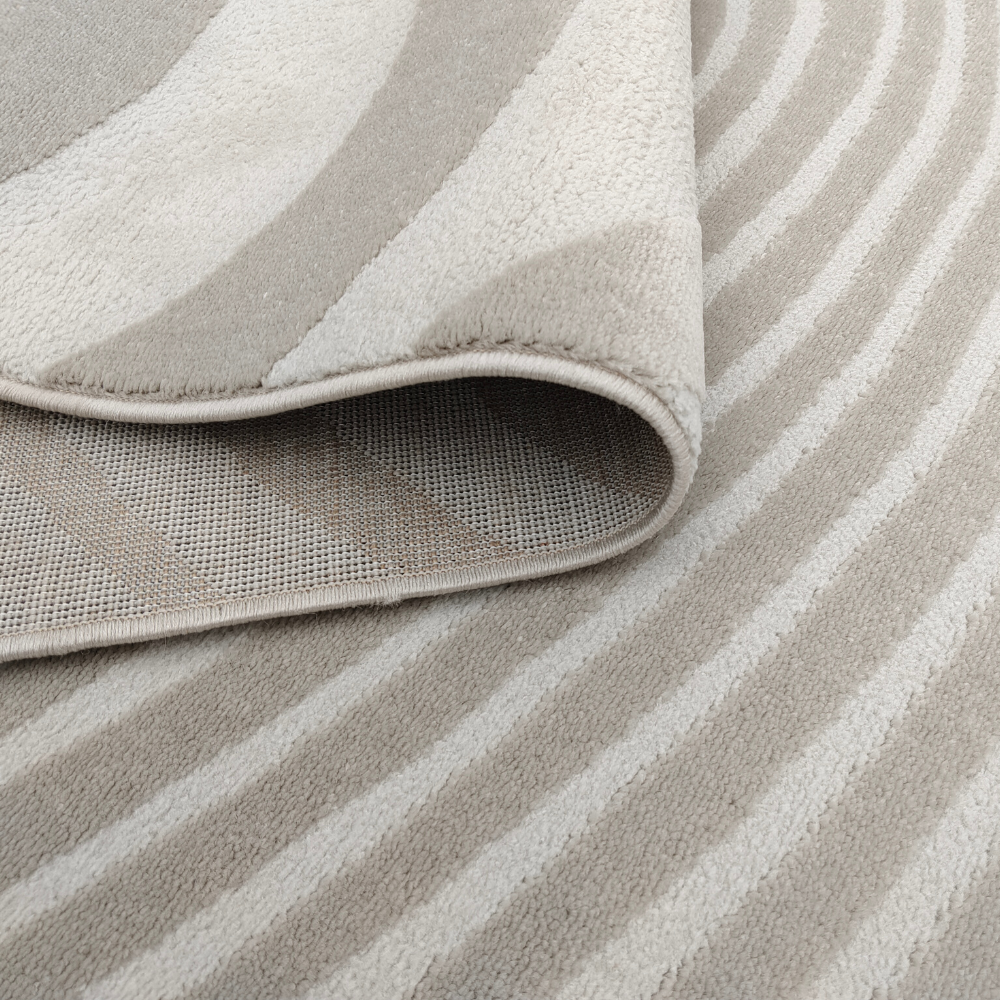 Beige textured rug with wavy patterns, ideal for contemporary home styling.