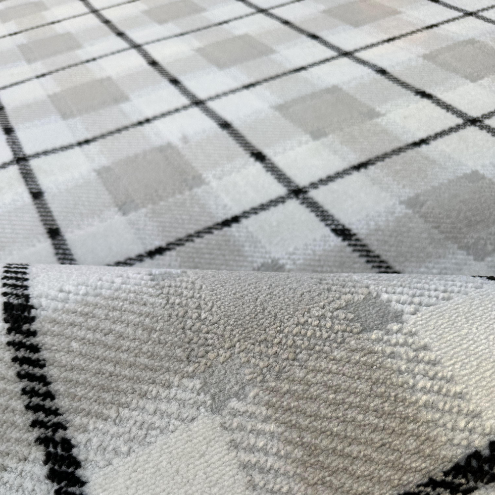 Lucian Checkered Textured Rug detail in soft gray and white with geometric design.