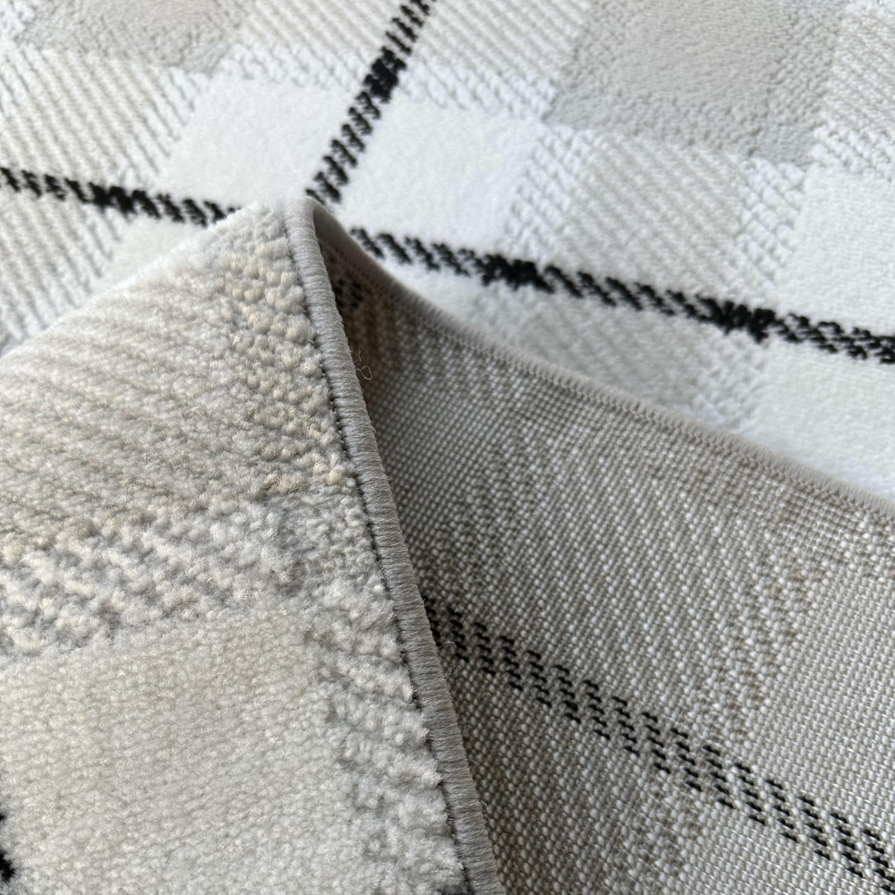Close-up of Lucian Checkered Rug in soft neutral colors and textured patterns