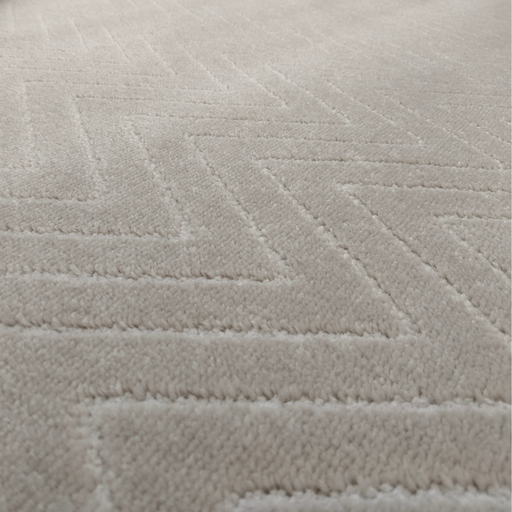 Soft beige chevron rug, ideal for enhancing home interiors with stylish texture.