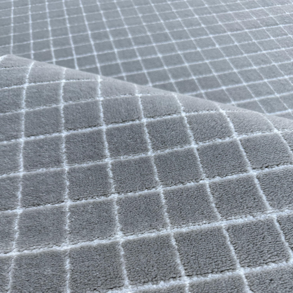 Gray geometric textured Zinnia rug with a soft grid design.