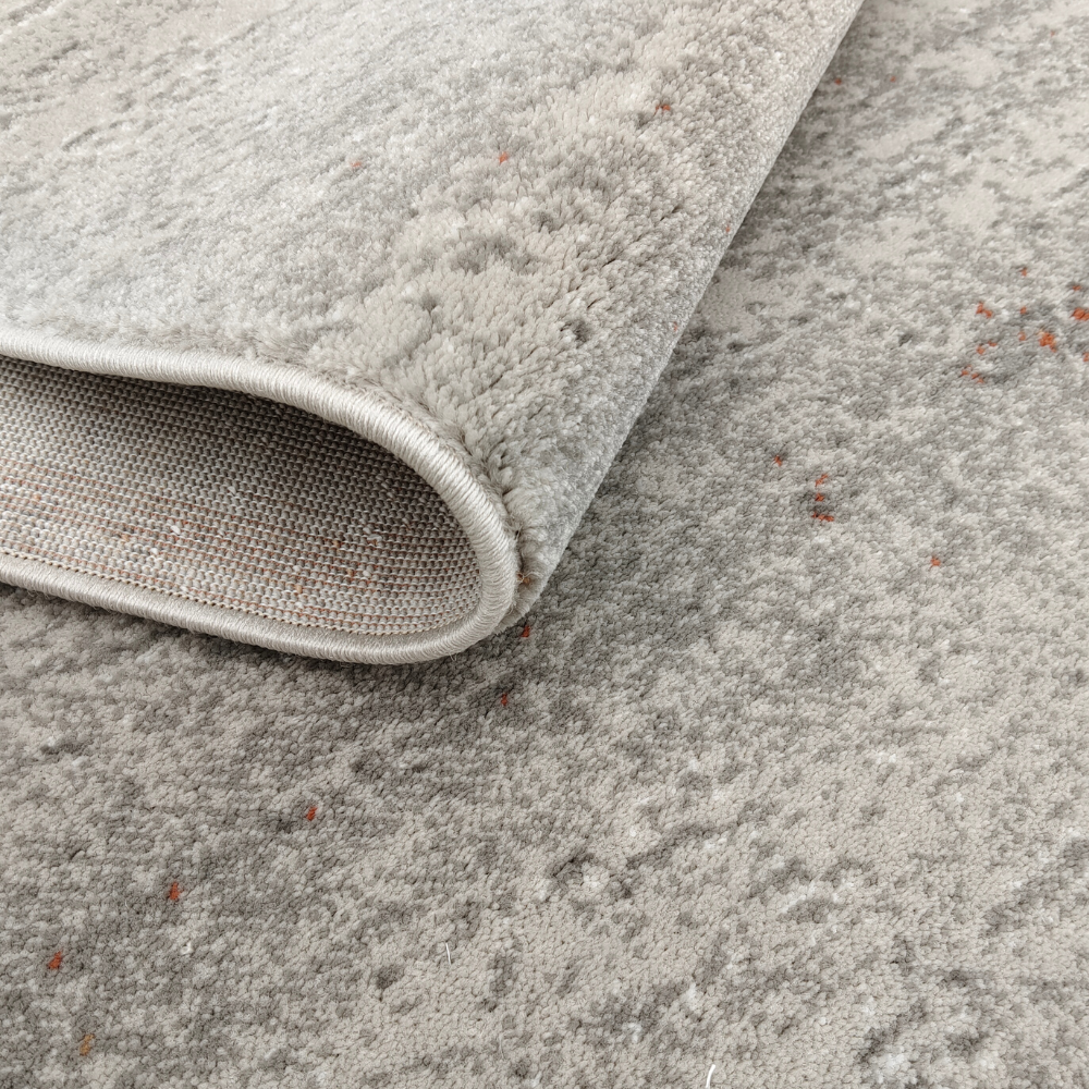 Leo Abstract Textured Rug in soft gray and orange tones, ideal for modern decor.
