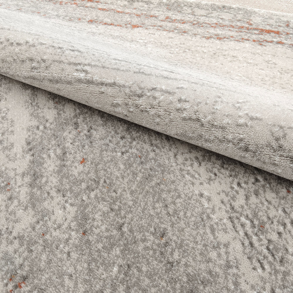 Leo Abstract Textured Rug in soft gray with orange accents, perfect for modern interiors.