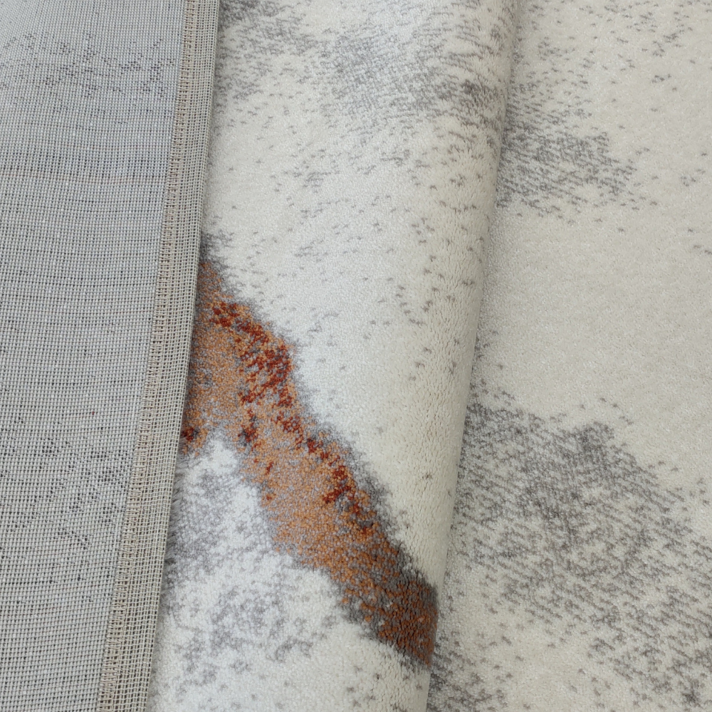 Iris Abstract Textured Rug in gray and rust, ideal for chic, washable home decor.