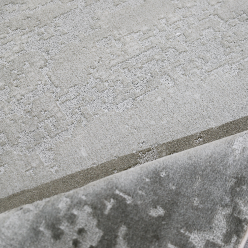 Light gray woven rug with intricate texture, perfect for modern home interiors.