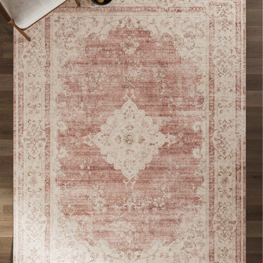 Vintage pink and cream floral rug adding elegance to a cozy living space.