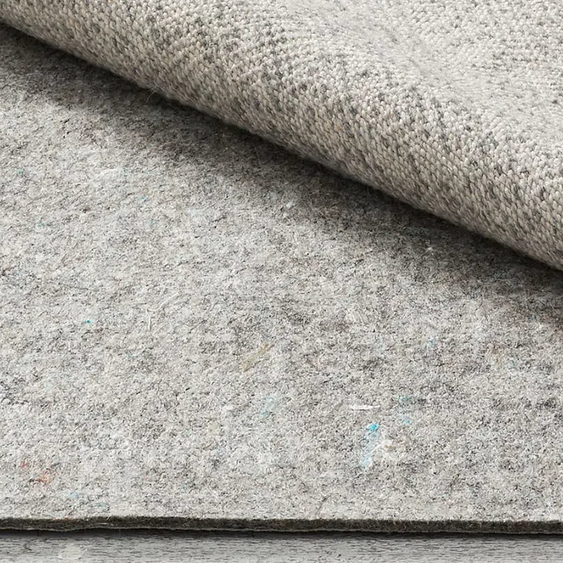 Gray rug pad providing stability and comfort for home rugs.