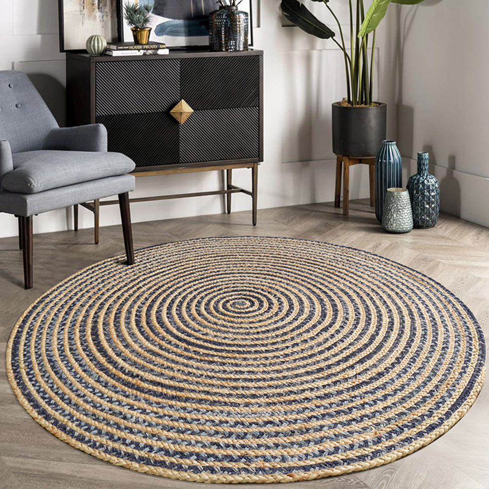 Round striped woven rug in natural tones enhancing modern living space decor.