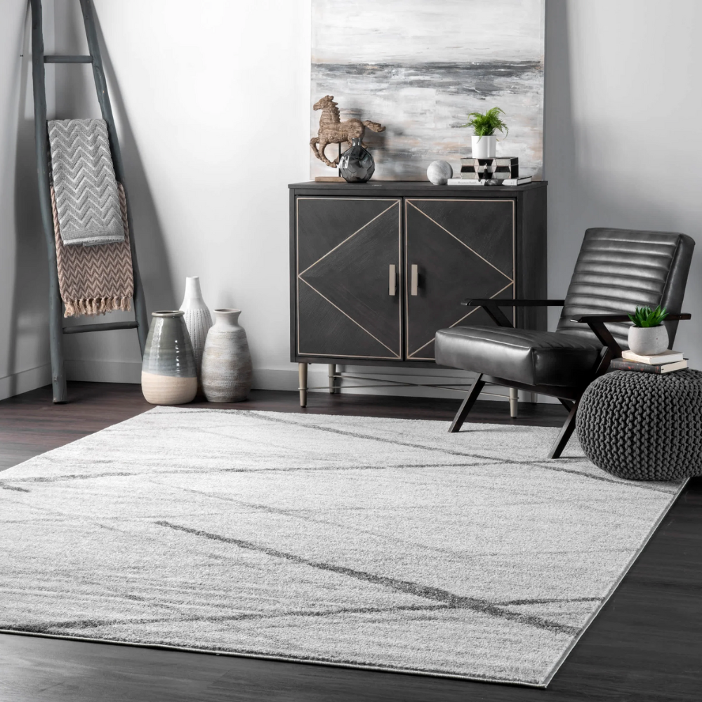 Gray and white geometric Zephyrus Stripes washable rug in stylish living room setting.