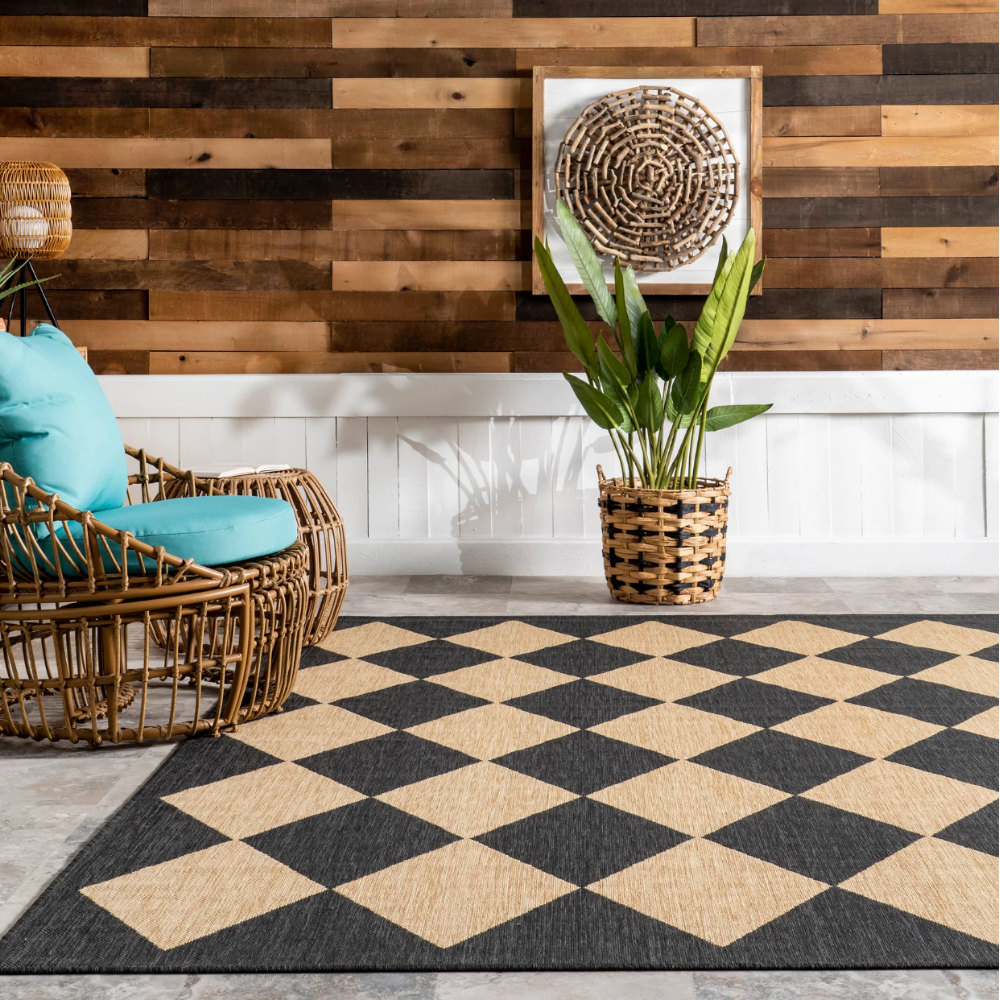 Damian checkered washable rug in black and beige diamond pattern on modern floor.