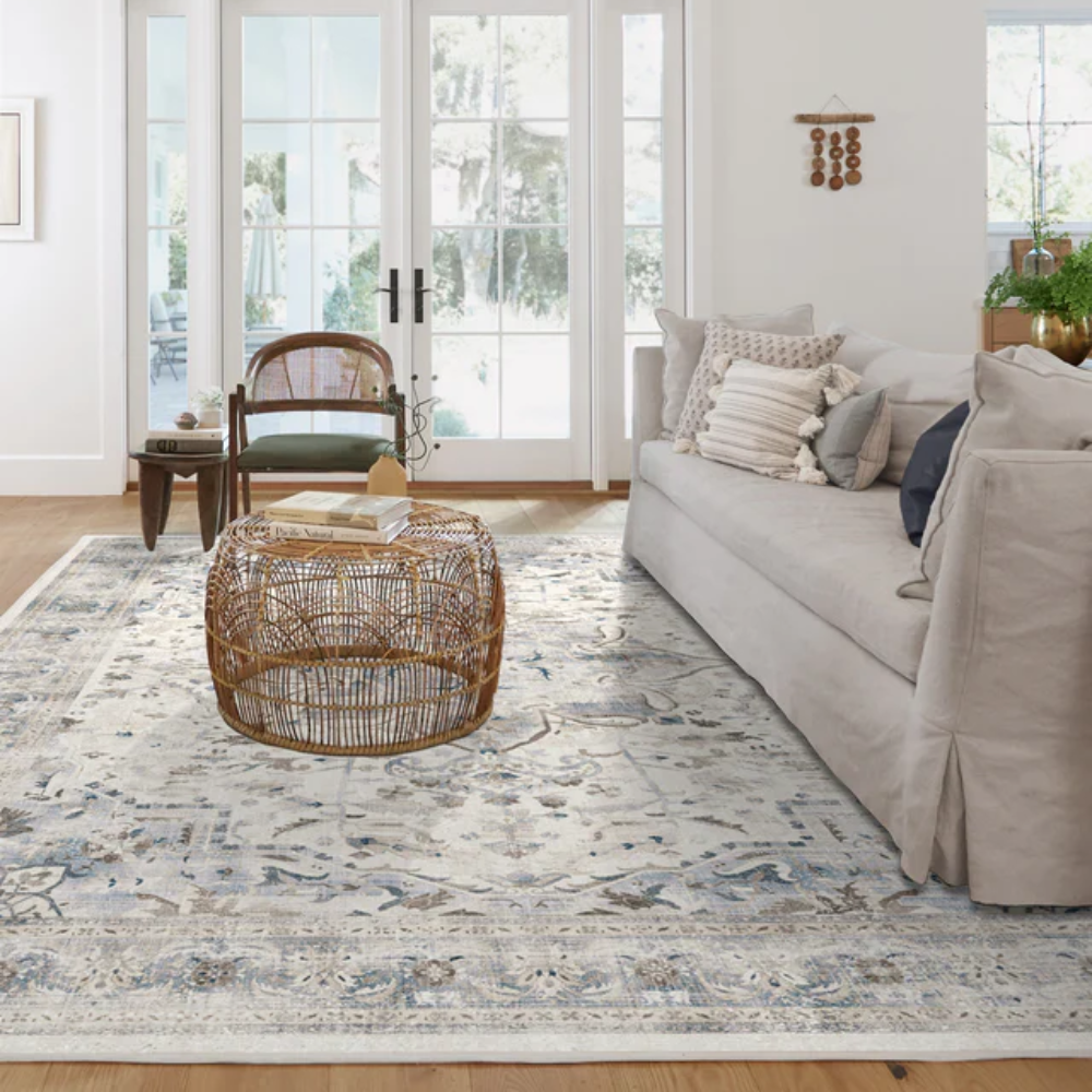 Orpheus Vintage Washable Rug in blue and cream, enhancing a bright living room