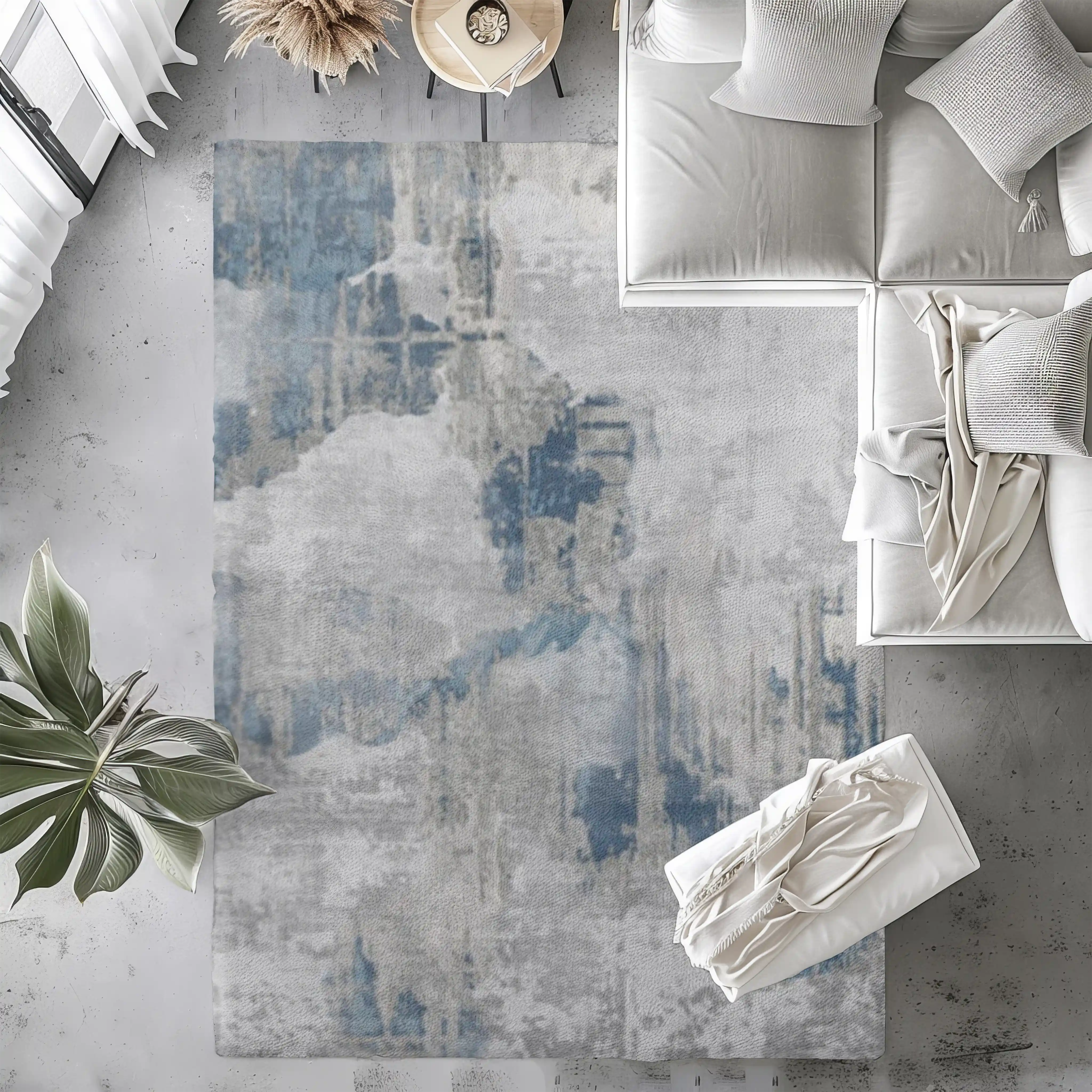 Faded abstract blue and gray washable rug in modern living room setting.