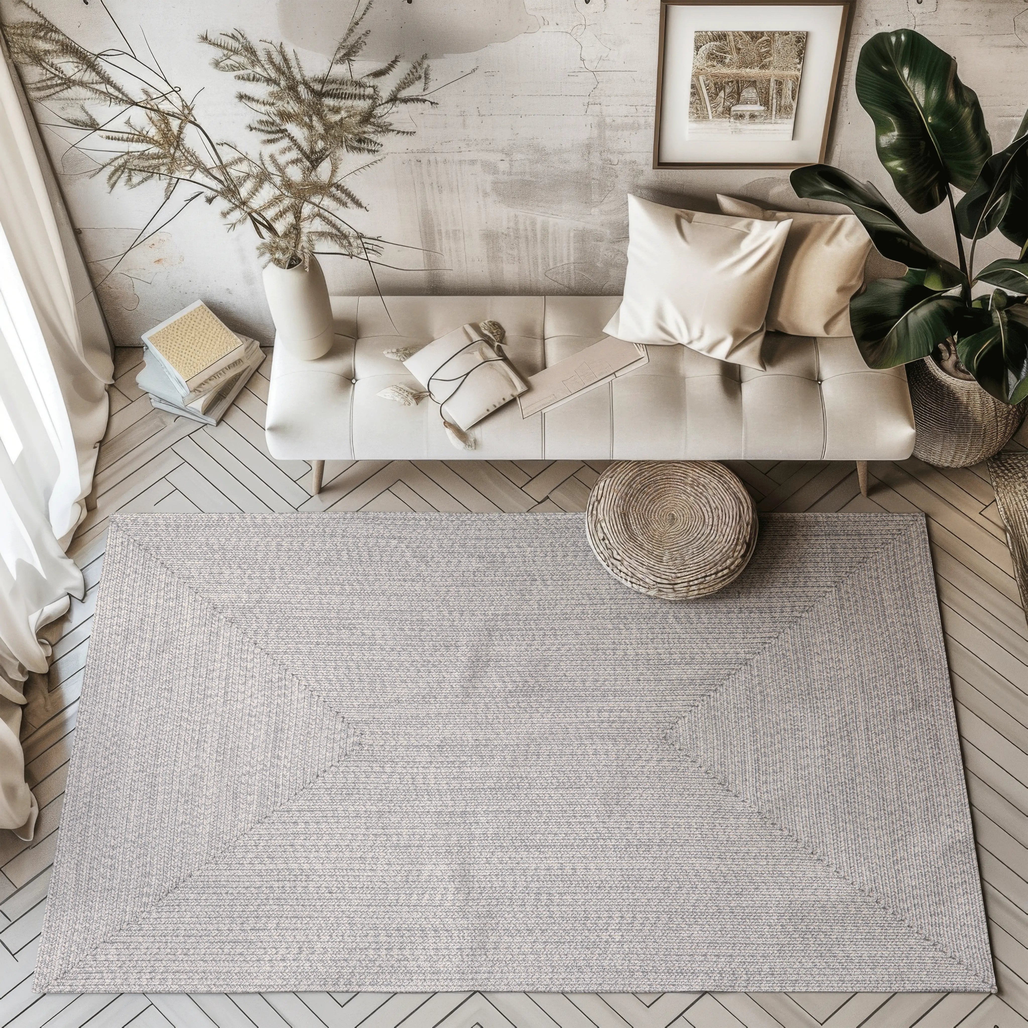 Hand-braided light gray outdoor rug in a modern living room setting.