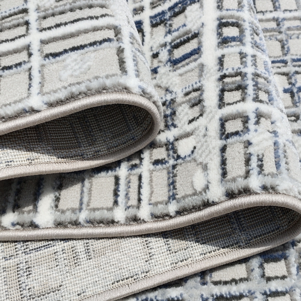 Felix Abstract Textured Rug featuring blue and white geometric design