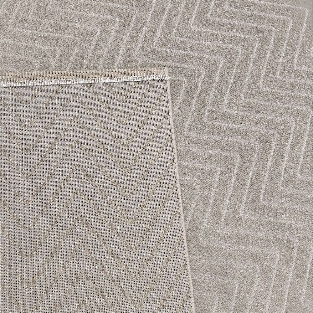 Soft beige chevron textured rug, ideal for stylish home decor.