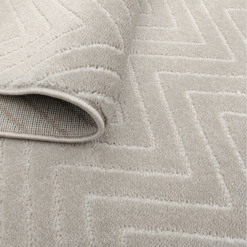 Textured beige chevron rug perfect for home decor.